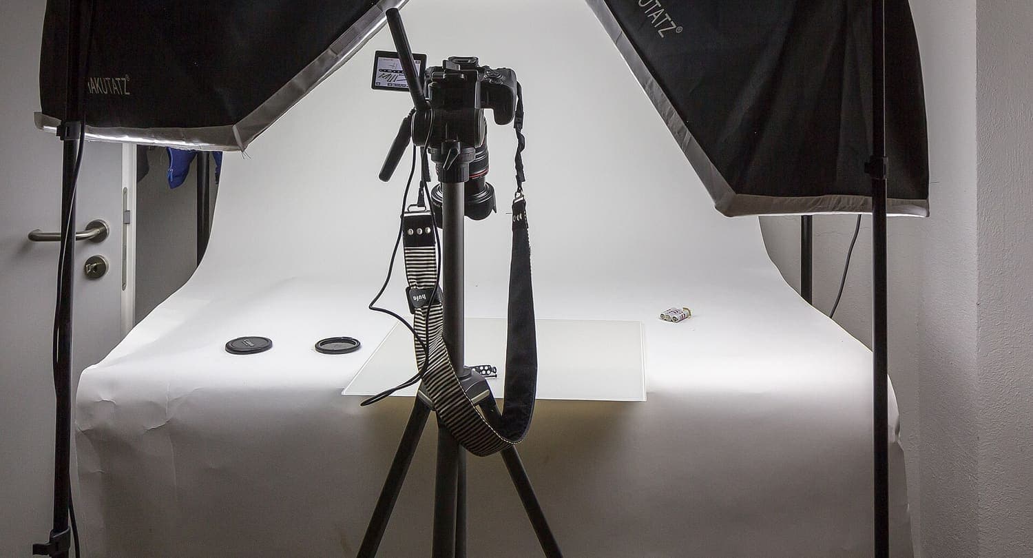 Placeholder — a document photography counter with white backdrop and studio lighting